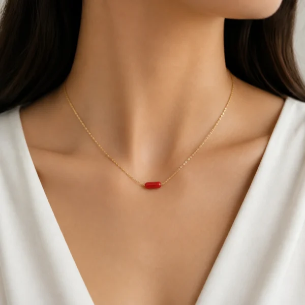 Collier or 18k et tube corail véritable
